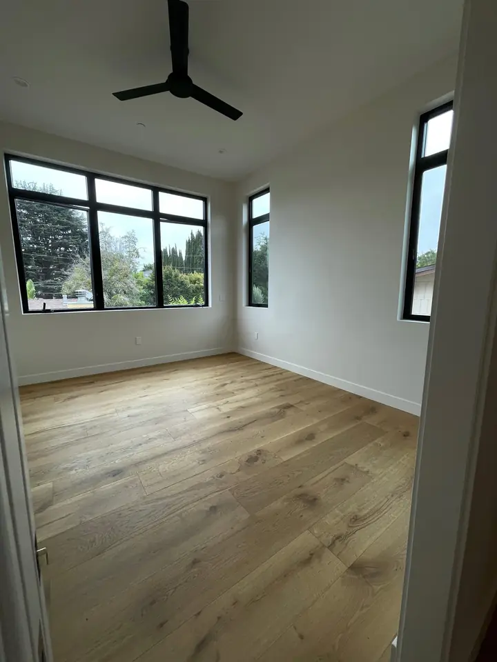 Bright bedroom with vaulted ceiling and freshly painted white walls