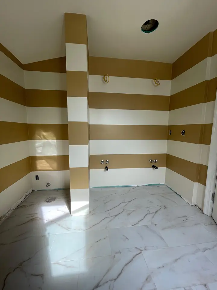 Commercial lobby with gold and white striped feature walls on marble floor