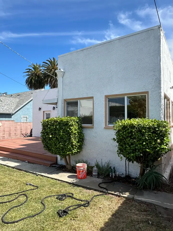 Spanish style home with newly painted white stucco exterior