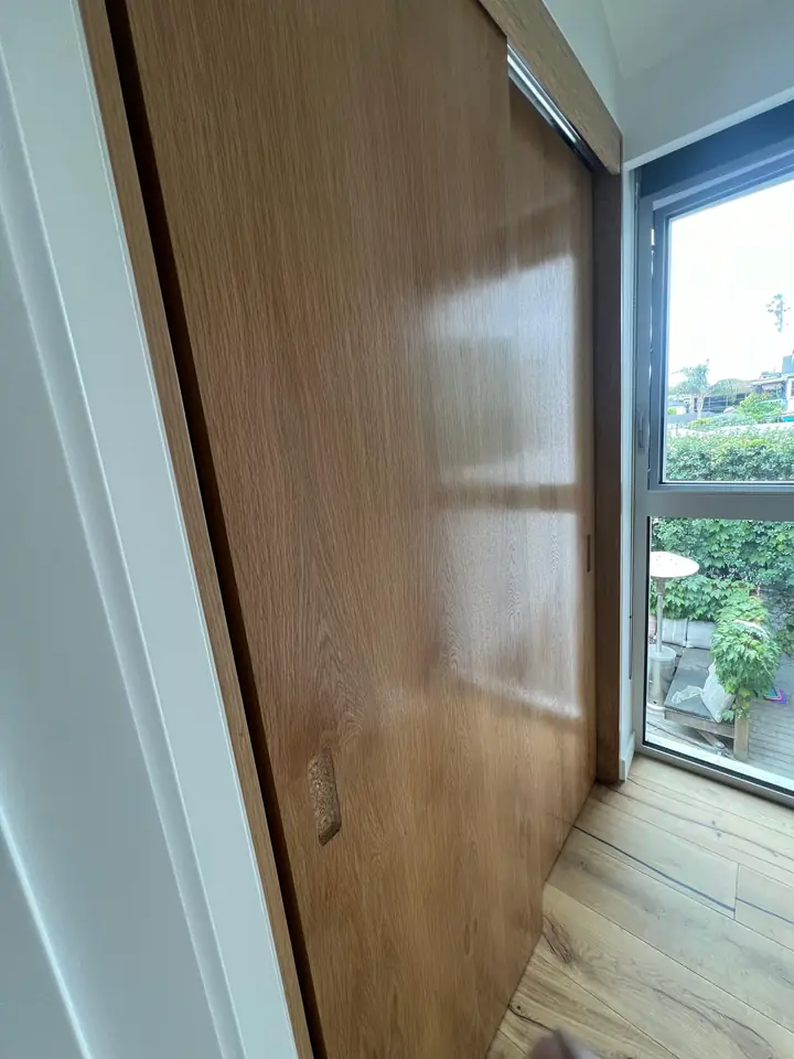 Finished interior with stained wood door and painted walls