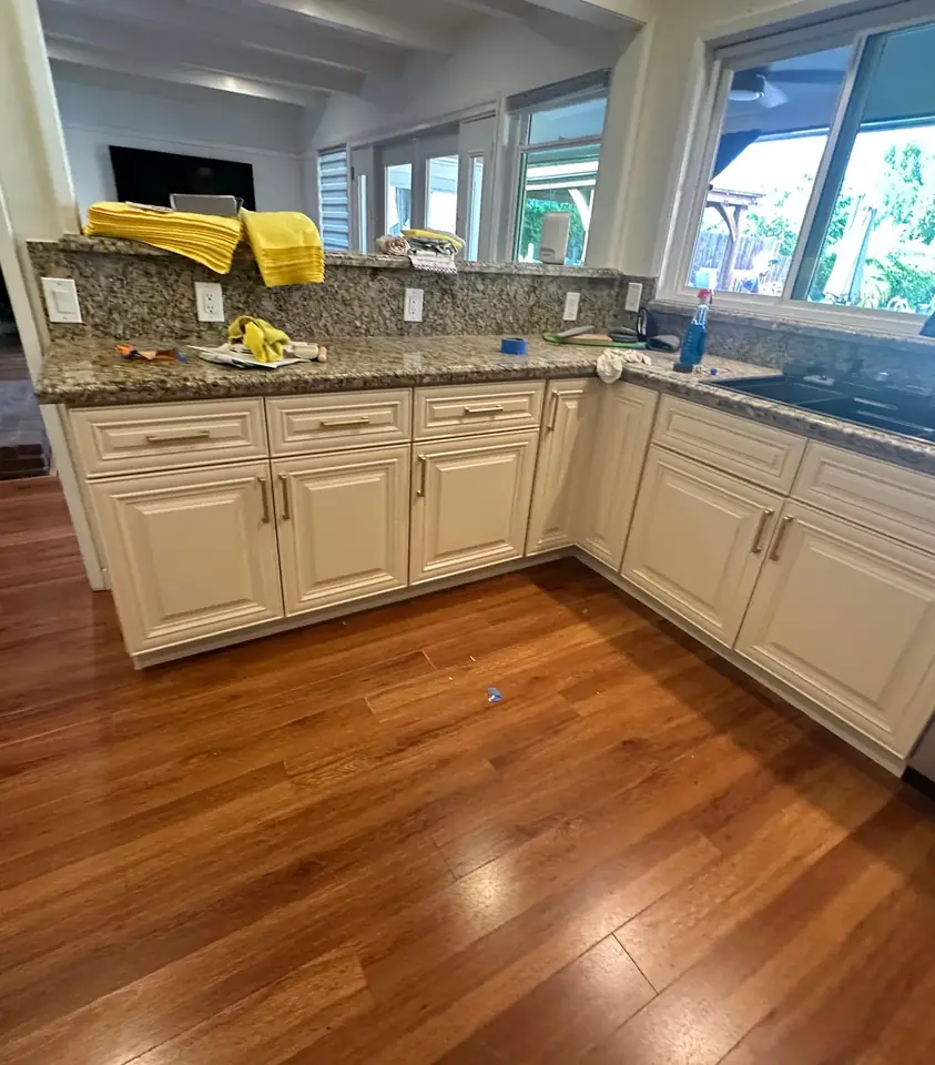 Traditional kitchen with cream cabinets and hardwood floors freshly painted