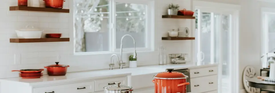 Bright kitchen with open shelving and freshly painted white walls